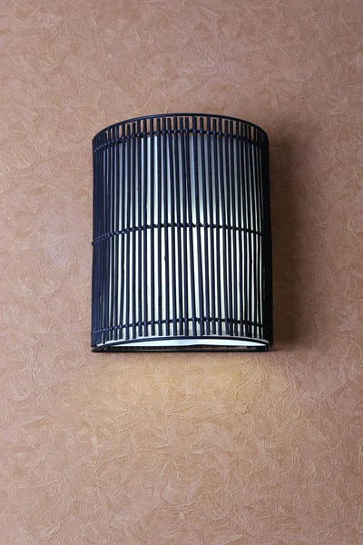 Modern lamp on wall in room — Stock Photo, Image