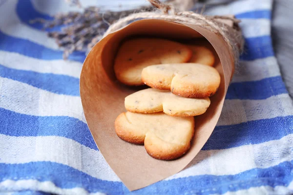 Lavender cookies in paper bag, on color napkin background — Stock Photo, Image