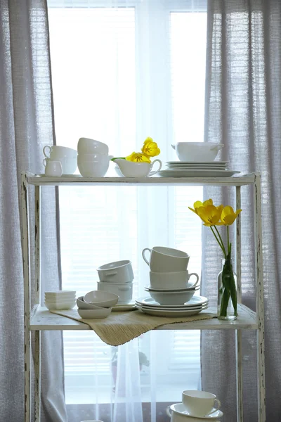 Different tableware on shelf in the interior — Stock Photo, Image