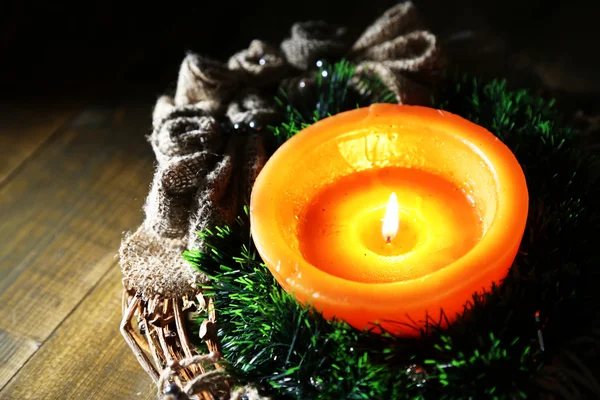 Burning candle with Christmas decorations on wooden background — Stock Photo, Image