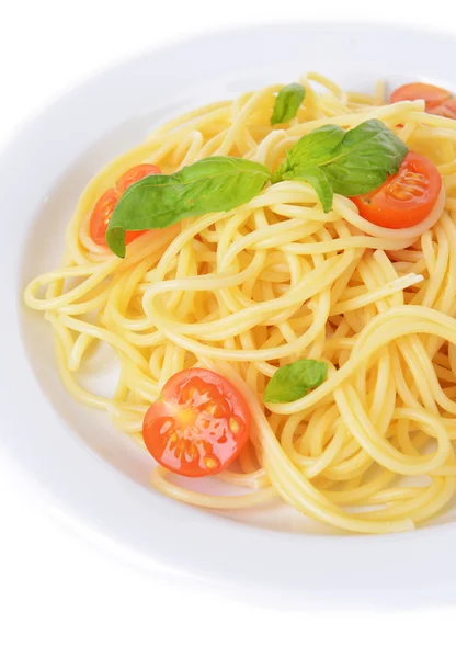 Delicious spaghetti with tomatoes on plate close-up — Stock Photo, Image