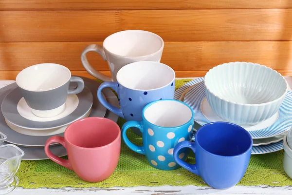 Different tableware on shelf, on wooden background — Stock Photo, Image