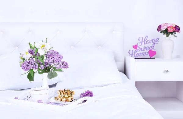 Wooden tray with light breakfast on bed — Stock Photo, Image