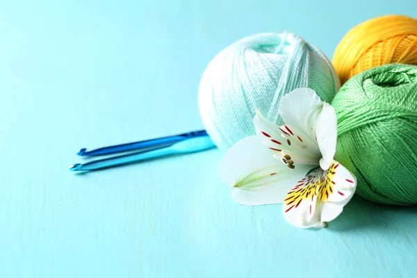 Colorful clews and crochet hooks on wooden background — Stock Photo, Image