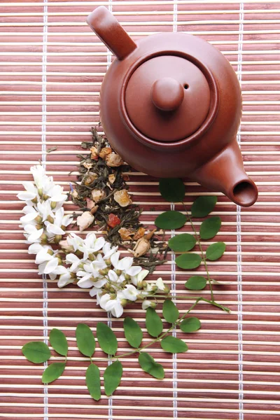 Herbal natural floral tea infusion with dry flowers ingredients, on bamboo mat background — Stock Photo, Image