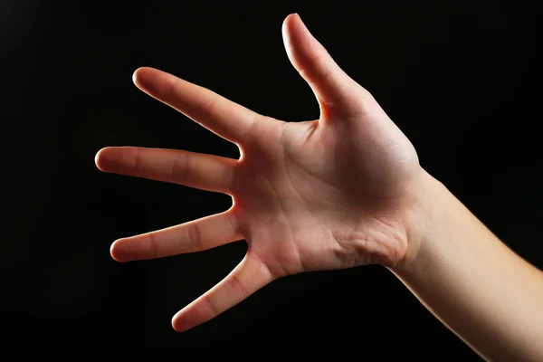 Human hand on black background — Stock Photo, Image