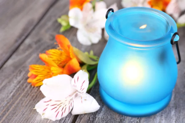 Bright icon-lamp with flowers on wooden background — Stock Photo, Image