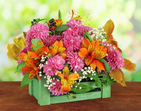 Flowers composition in crate on table on bright background — Stock Photo, Image