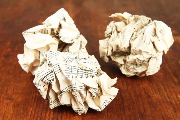 Crumpled paper balls on wooden background