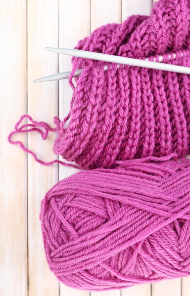 Knitting with spokes on wooden background — Stock Photo, Image