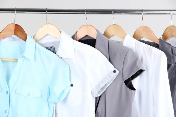 Office female clothes on hangers, on gray background — Stock Photo, Image