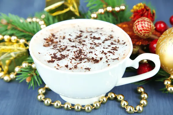 Hot chocolate with cream in color mug, on table, on Christmas decorations background — Stock Photo, Image