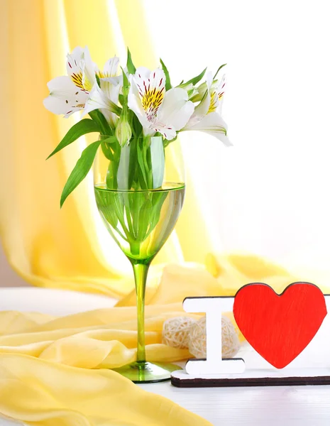 Freesias in glass on table — Stock Photo, Image