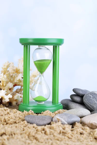 Hourglass in sand — Stock Photo, Image