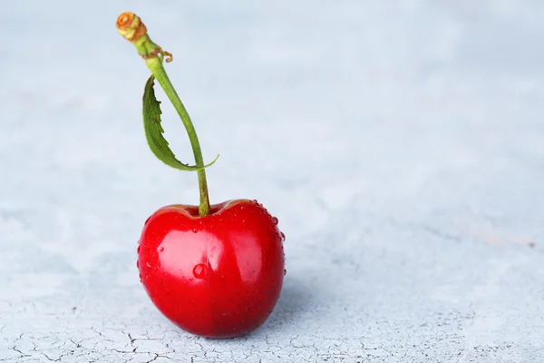 Ripe sweet cherry on grey background — Stock Photo, Image