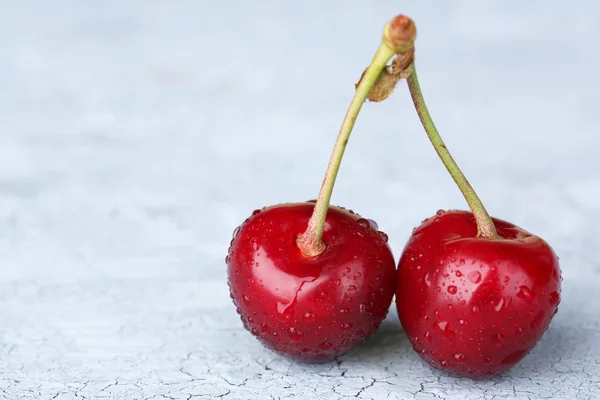 Ripe sweet cherries on grey background — Stock Photo, Image