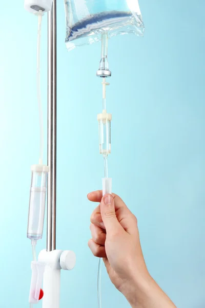 Disposable infusion set on blue background — Stock Photo, Image
