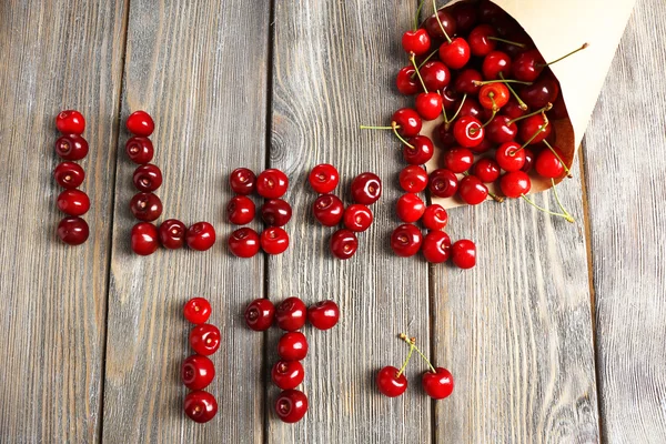 Sweet cherries on wooden table — Stock Photo, Image