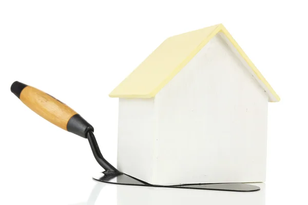 Wooden toy house on trowel and tiles, isolated on white — Stock Photo, Image