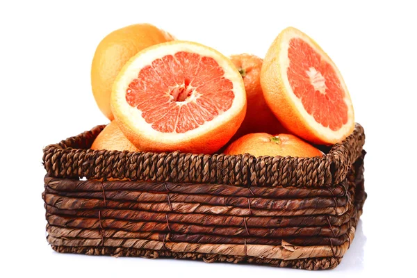 Ripe grapefruits in wicker basket isolated on white — Stock Photo, Image