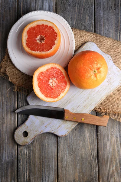完熟グレープ フルーツとまな板木製の背景上にナイフ — ストック写真