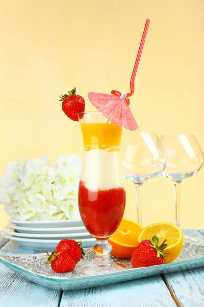 Delicious fruit smoothie on wooden table on light background — Stock Photo, Image