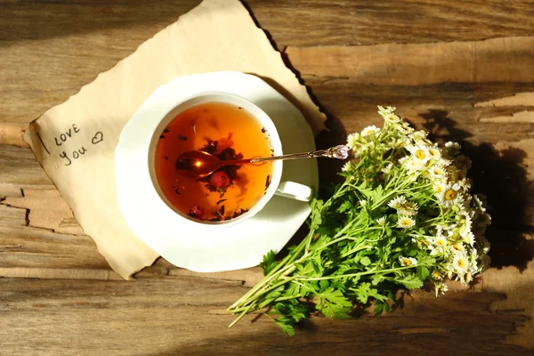 Cup of fresh herbal tea on wooden table — Stock Photo, Image