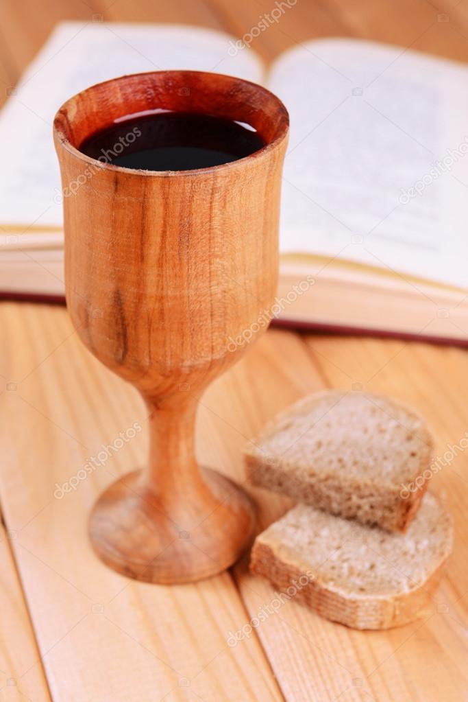 Cup of wine and bread on table close-up