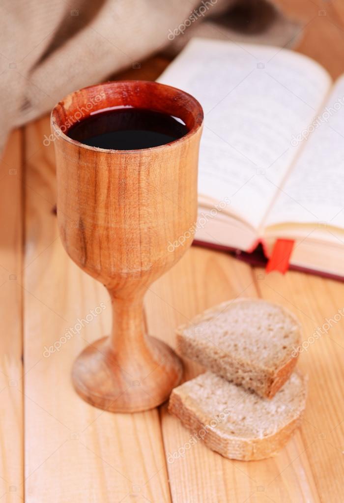Cup of wine and bread on table close-up