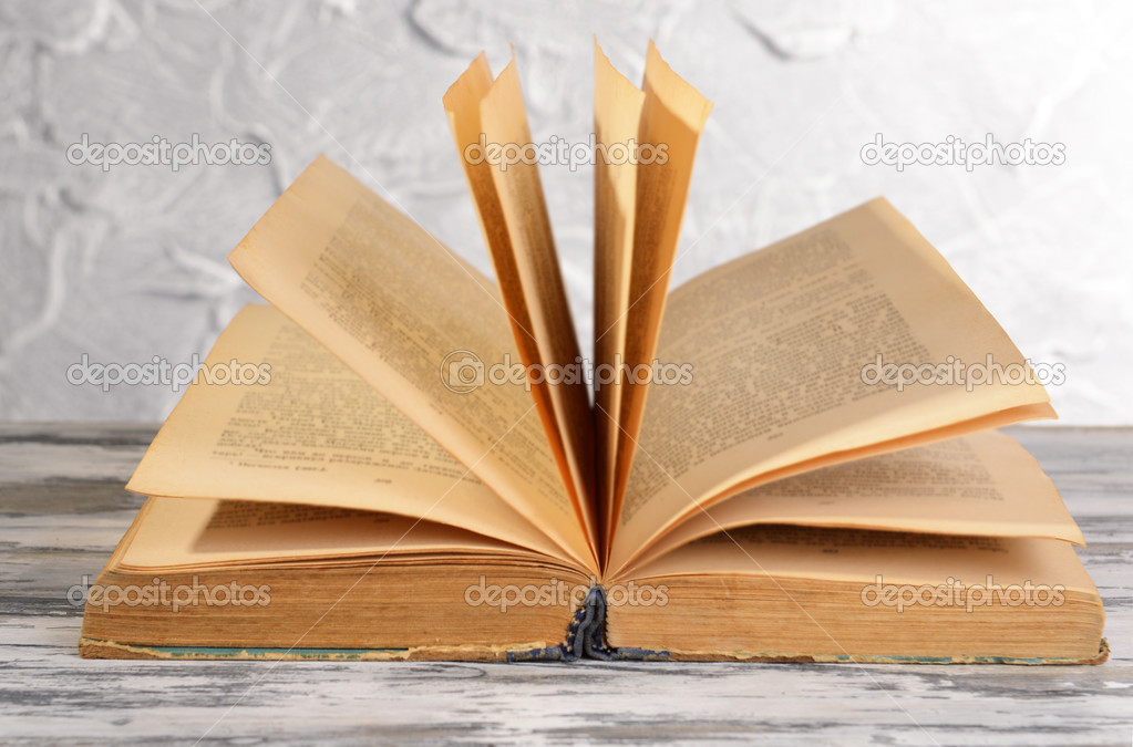 Old book on table on grey background