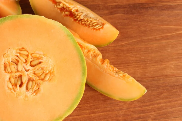 Cut melon on wooden background close-up — Stock Photo, Image