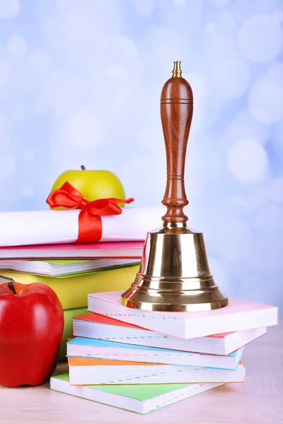 Gold school bell with school supplies — Stock Photo, Image