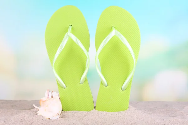 Bright flip-flops on sand — Stock Photo, Image