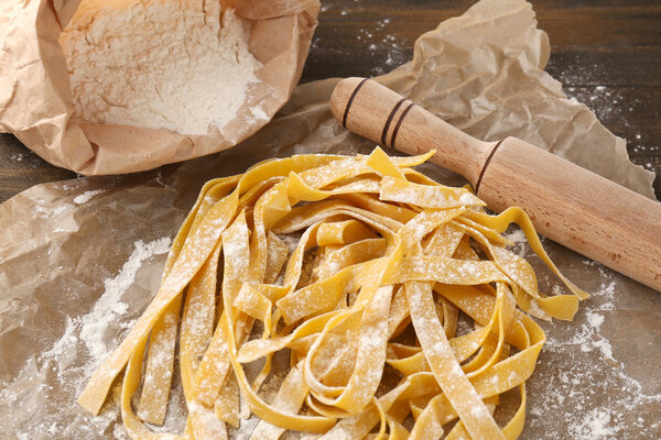 Still life with raw homemade pasta and ingredients for pasta