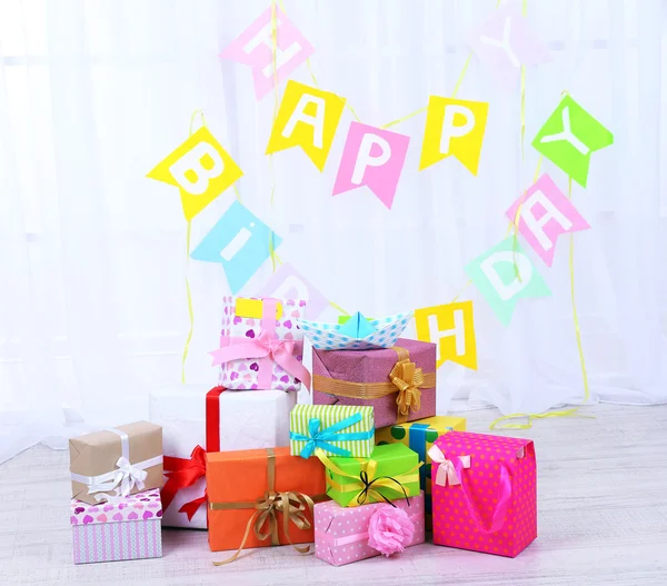 Many birthday gifts in room — Stock Photo, Image