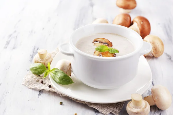 Mushroom soup in white pot, on napkin, on wooden background — Stock Image Mushroom soup in white pot, on napkin, on wooden background Stock Image