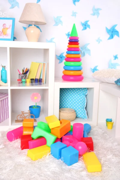 Colorful plastic toys in children room — Stock Photo, Image