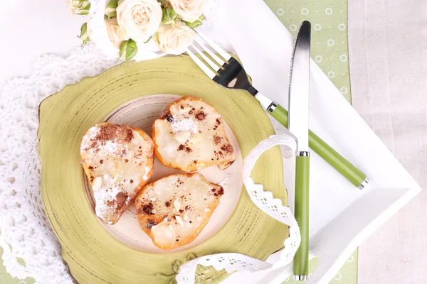 Baked pears with syrup on plate, on wooden tray, on tablecloth background — Stock Photo, Image