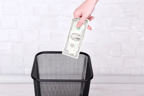 Throwing away your money on grey wall background — Stock Photo, Image