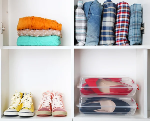 Clothes and shoes on shelves close-up — Stock Photo, Image