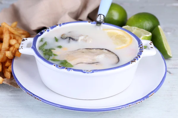 Tasty soup with oysters on wooden table — Stock Photo, Image