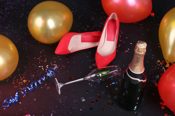 Schuhe mit Konfetti, Champagner und Luftballons am Boden — Stockfoto