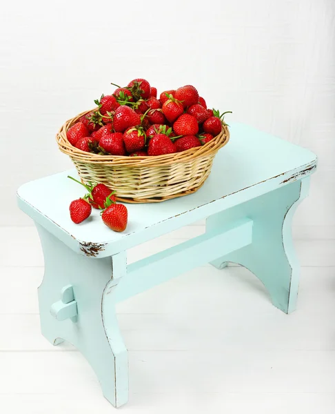 Fresh strawberries in basket on white wall background — Stock Photo, Image