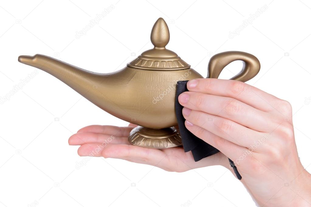 Magic lamp in female hands isolated on white