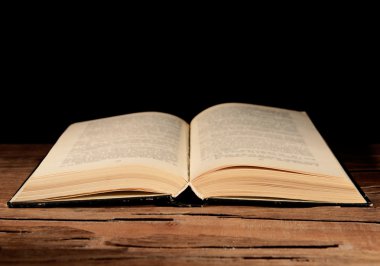 siyah arka plan üzerine masada eski kitap