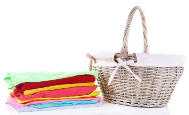 Bright clothes and empty wicker basket, isolated on white