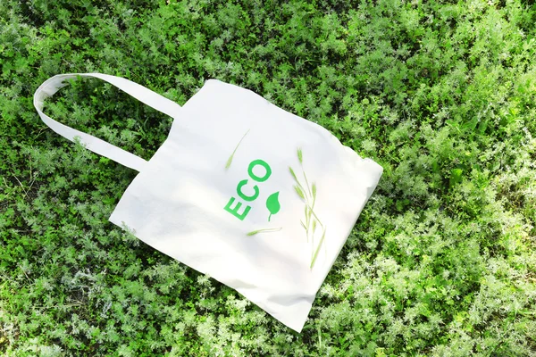 Eco bag on green grass, outdoors — Stock Photo, Image