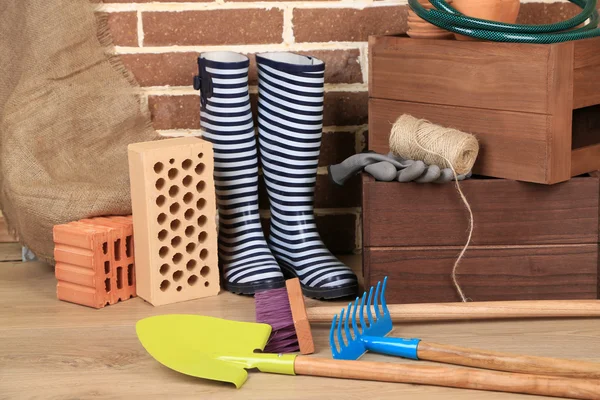 Herramientas de jardinero sobre fondo de ladrillos — Foto de Stock