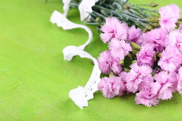 Beautiful bouquet with lace ribbon on wooden background — Stock Photo, Image