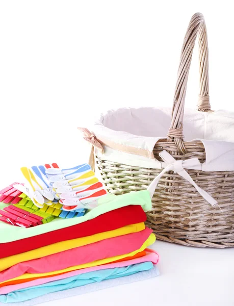 Bright clothes and empty wicker basket, isolated on white — Stok fotoğraf